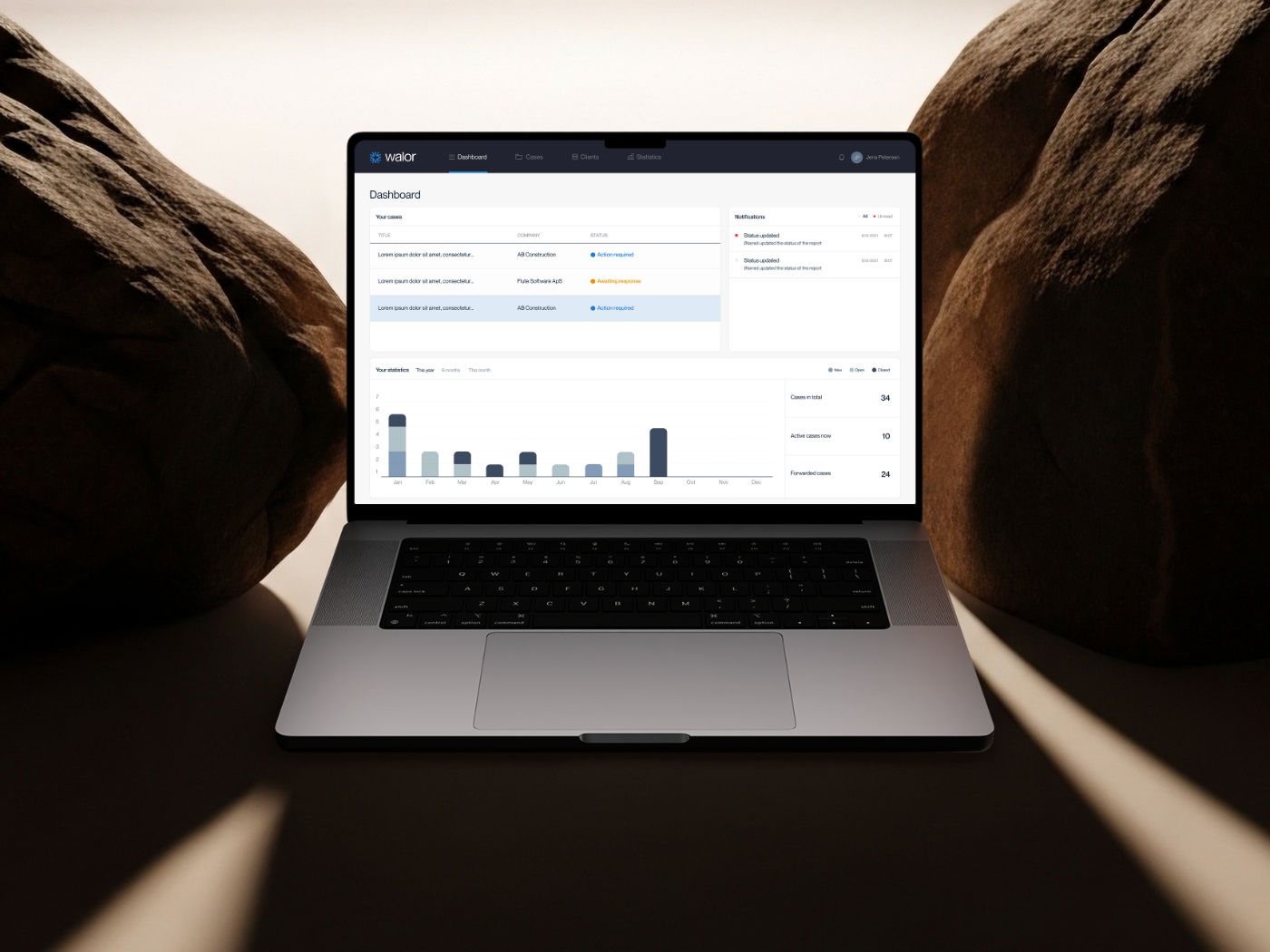 The Walor dashboard on a laptop between two stones